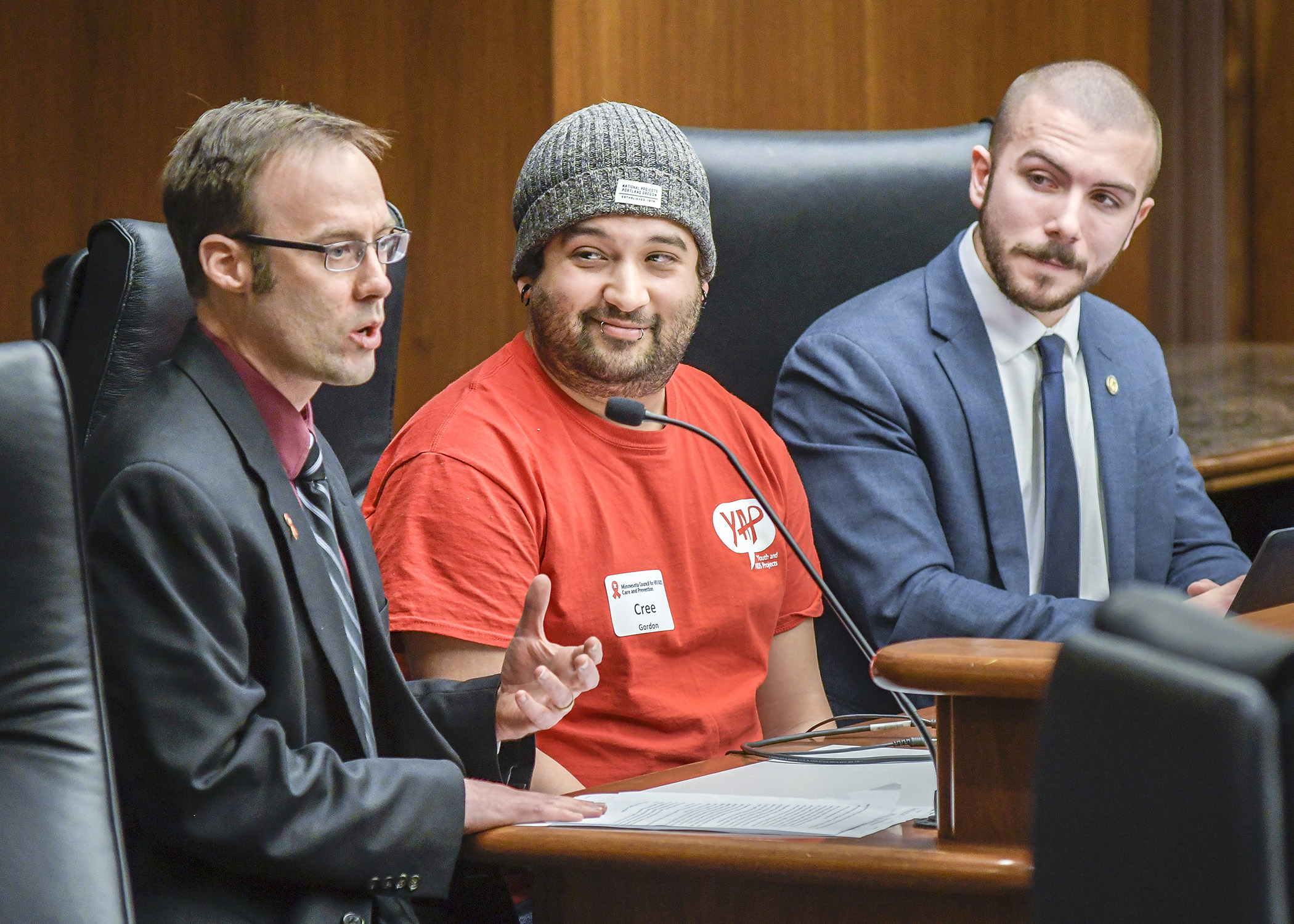 Matt Toburen, left, and Cree Gordon testify before the House Health and Human Services Finance Division Feb. 12 in support of a bill sponsored by Rep. Hunter Cantrell, right, that would provide HIV prevention grant funding. Photo by Andrew VonBank